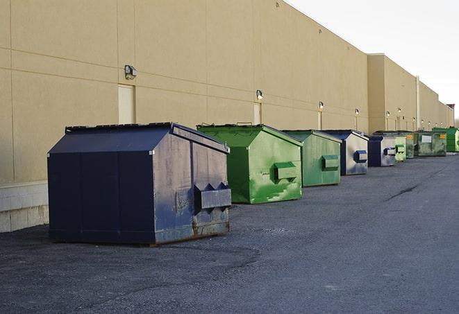 a fleet of red and blue construction dumpsters available for use in Akron